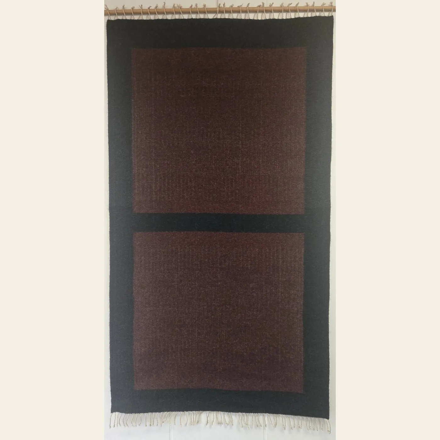 Hand-woven rug by Charles H. Blanchard, the Dyberry Weaver of Narrowsburg NY, with two deep brown panels set in a charcoal ground
